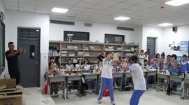 Wooden board flies over teacher during taekwondo demonstration