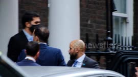 Israeli President Isaac Herzog departs Chatham House as protesters stage pots and pans protest outside