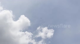 Stork on the Wind: Dreaming High in Blue Skies, an open billed stork is enjoying gliding higher and higher in the air currents
