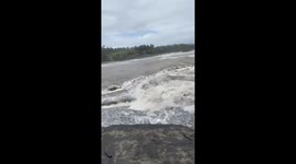 House collapses into river as floods kill 15 in Bali