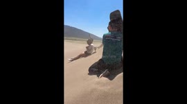 Influencers use boards to protect themselves from sudden sandstorm