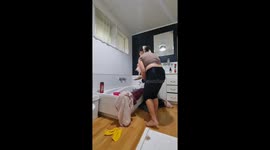 Bath time struggle with cat in Rotorua, New Zealand