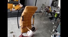 Mum takes pictures of daughter after she becomes stuck while playing on folding chair