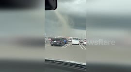 Tornado towers over car park during extreme weather spell in Japan
