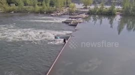 Surfers catch waves on weir along Boise River