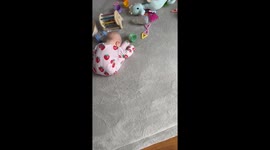 Baby falls asleep in funny folded position in Wrexham, Wales, UK