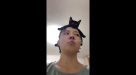 Black cat calmly sits on owner’s head in Tianjin, China