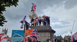 Marchers on 'Unite the Nation' demo climb statue and set off smoke flare