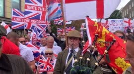 A man plays the bagpipes at Tommy Robinson's Unite the Kingdom rally