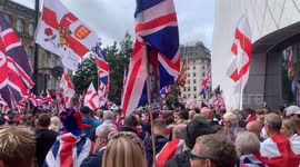 A protestor holds up a tribute to late US right wing social media influencer Charlie Kirk at Tommy Robinson's Unite the Kingdom rally