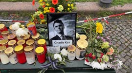 Flowers and photos are placed in memory of recent victims at a small pro-Israel counter-demonstration near Pariser Platz