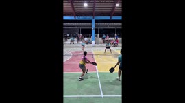 Pickleball player stumbles and falls into net when she misses shot