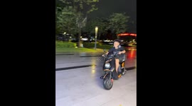 Passenger falls during scooter trick in Guangdong, China