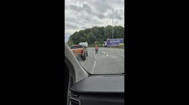 Man rides mobility scooter along road in Warrington, England, UK