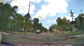 Car Crosses Tracks Before Passing Train