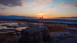 Drone captures American flag atop Black Rock near Great Salt Lake in Utah, USA