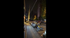 Man rides bicycle with three dogs in Beijing, China