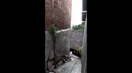 Two children narrowly escape from house collapsing after heavy rain in Indonesia