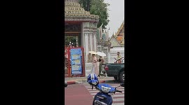 Three guys wear traditional Thai silk outfits on holiday