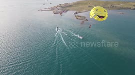 Parasailing over green water