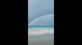Beautiful double rainbow stretches over tourist island Boracay