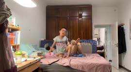 Little boy bounces on bed and hits head on wall in Beijing, China