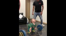 Little boy lifts toy barbell to applause in Brazil