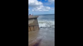 Woman Gets Soaked By Incoming Wave