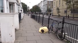 Yellow mummy lie-down outside Earls Court station on Warwick Road in London