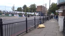 Yellow mummy lie-down outside Earls Court station on Warwick Road in London
