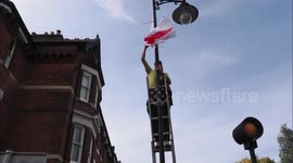 Counter protestors de-flag lampposts in Faversham, UK