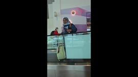 Frantic passenger chases her runaway suitcase on airport travelator