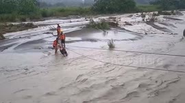Coast Guard helps residents cross surging river during Typhoon Ragasa