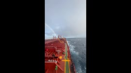 Beautiful rainbow forms across tanker ship in Pacific Ocean