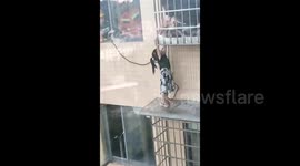 Young girl plunges from 20th floor onto canopy before heroic neighbours save her in dramatic rescue