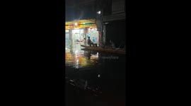 Dragon boat rowing through flooded street in Guangdong, China