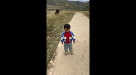 Sleepy child’s nap ends with a tumble on the road in Sichuan, China