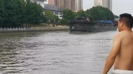 Onlooker rescues woman whose car crashed into river