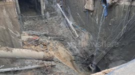 Workers retrieving car narrowly avoid being dragged into sinkhole