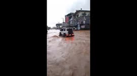 Vehicles navigate waterlogged roads after Typhoon Ragasa onslaught in the Philippines