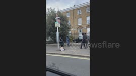 Shocking moment knife-wielding youth chases after teens in middle of Brixton street as terrified bystanders scream