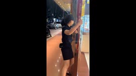 Woman struggles against strong typhoon winds in Guangxi, China