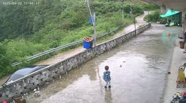 Man loses balance carrying heavy bucket in Yunnan, China