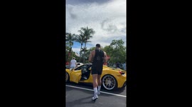 Giant 6’10” bodybuilder squeezes into tiny Ferrari — viral sensation