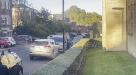 A police car with blue lights arrives at the scene of car chase.