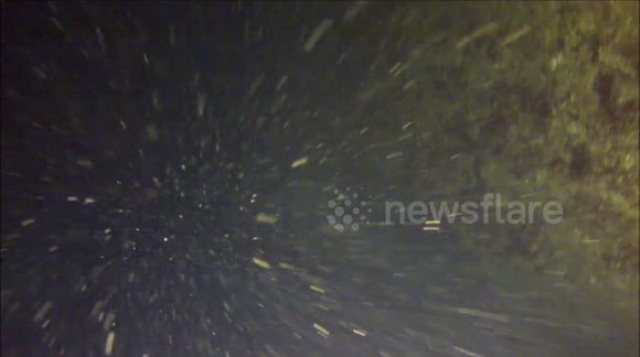 Two Divers Exploring a underwater cave network find a `Air pocket` .