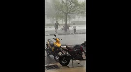 Youngsters brave strong wind and rain to help deliveryman caught in storm