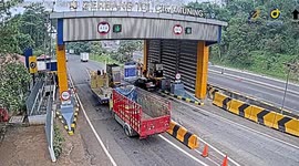 Out-of-control truck crashes through toll booth in Indonesia