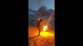 Man plays with flaming football on beach in Puerto Viejo, Costa Rica