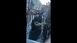Women scream while leaving gondola during Venice tour, Italy